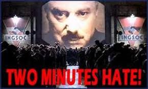 The image depicts a scene from George Orwell's dystopian novel Nineteen Eighty-Four. Big Brother: The large face on the screen represents Big Brother, the enigmatic and all-seeing leader of the totalitarian state of Oceania. Two Minutes Hate: The crowd gathered below is participating in the 