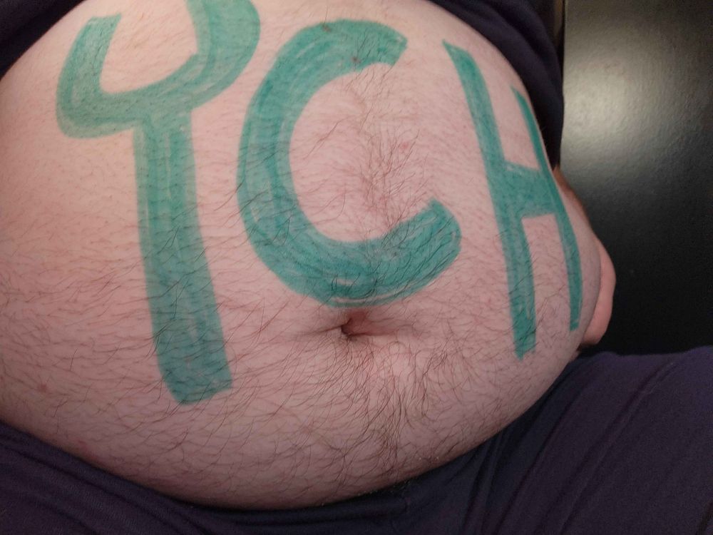 Fat belly with the letters "YCH" representing the phrase "Your Character Here" a common sight in pre-planned art commissions. The implication is that your character is in "here" as in, in the belly.