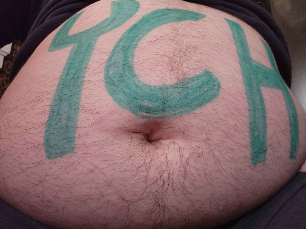 Fat belly with the letters "YCH" representing the phrase "Your Character Here" a common sight in pre-planned art commissions. The implication is that your character is in "here" as in, in the belly.