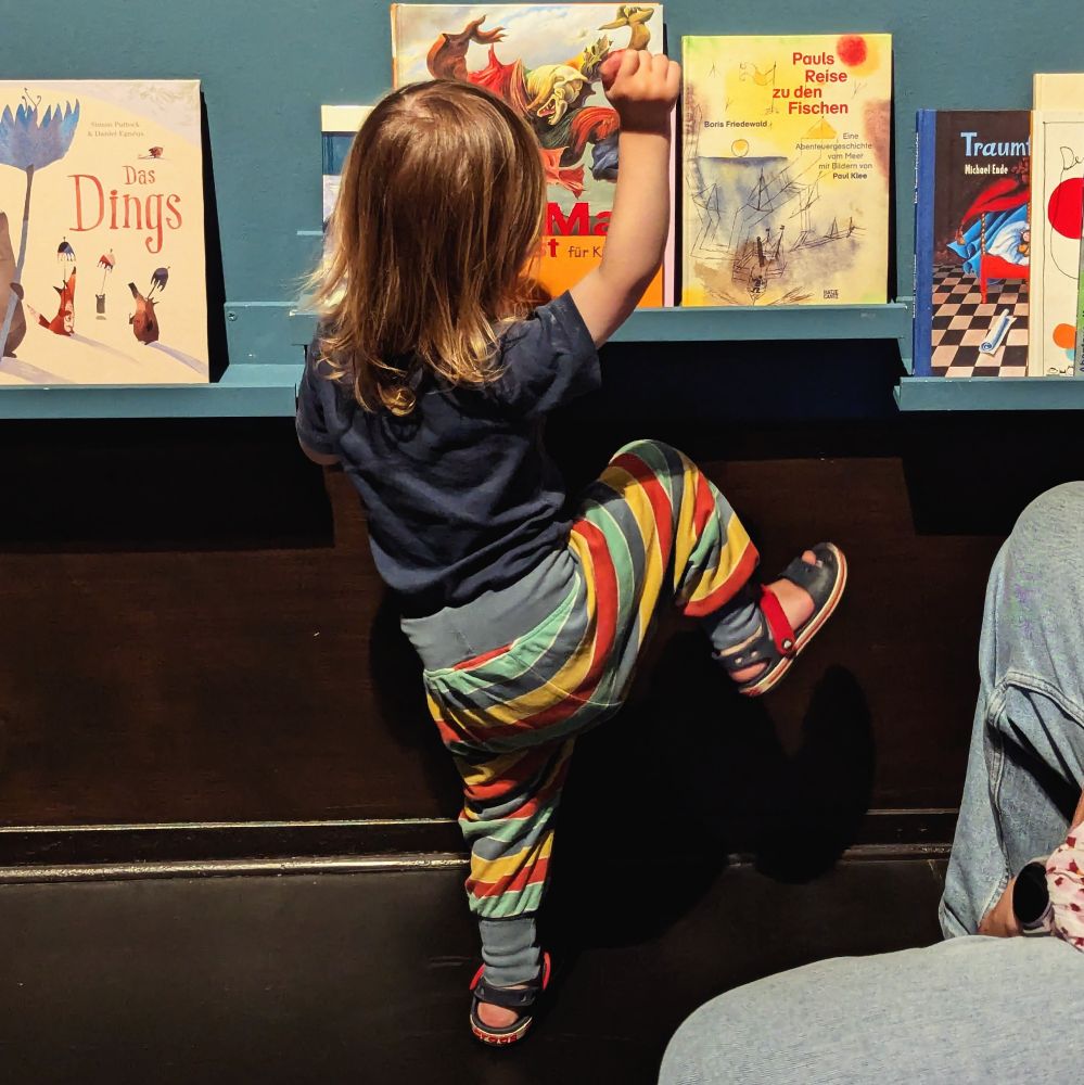 Toddler mimicking the pose of Der Engel Des Herdes by Max Ernst.