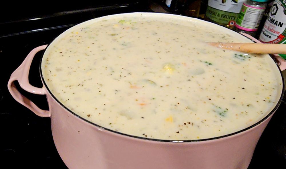 Creamy soup in a pot, almost filled to the top.