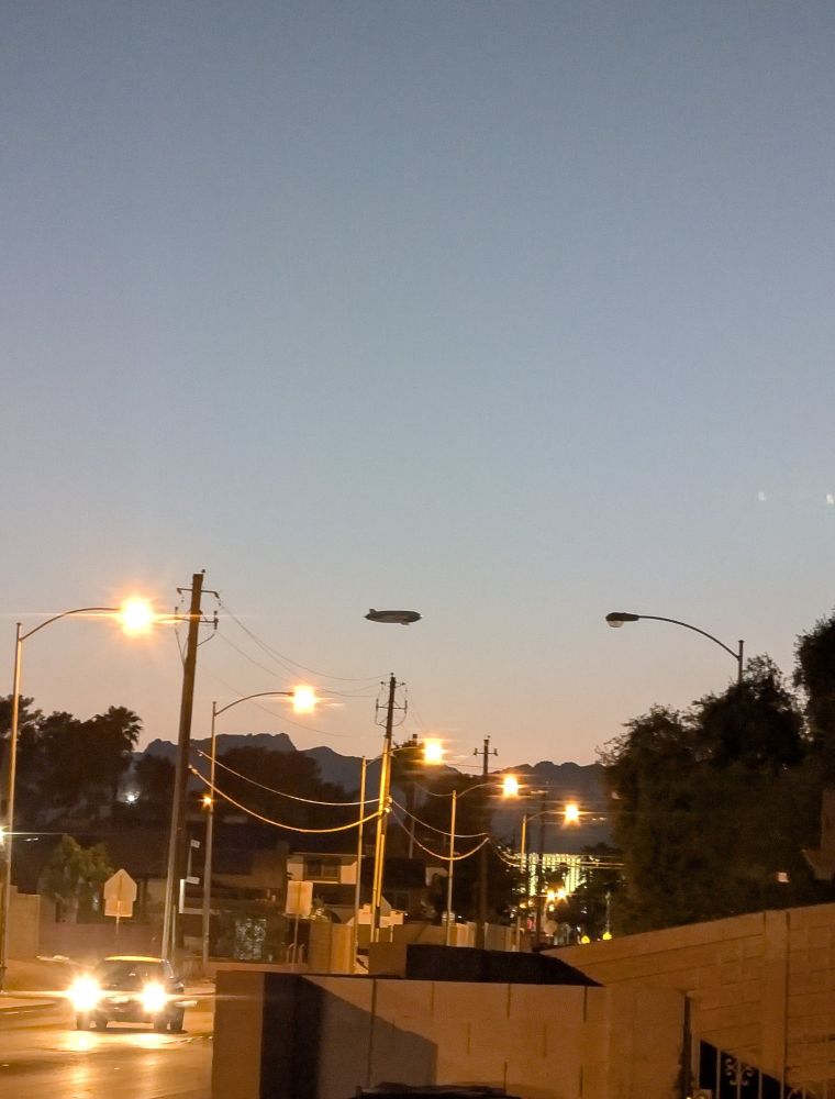 A blimp on the horizon during sunset