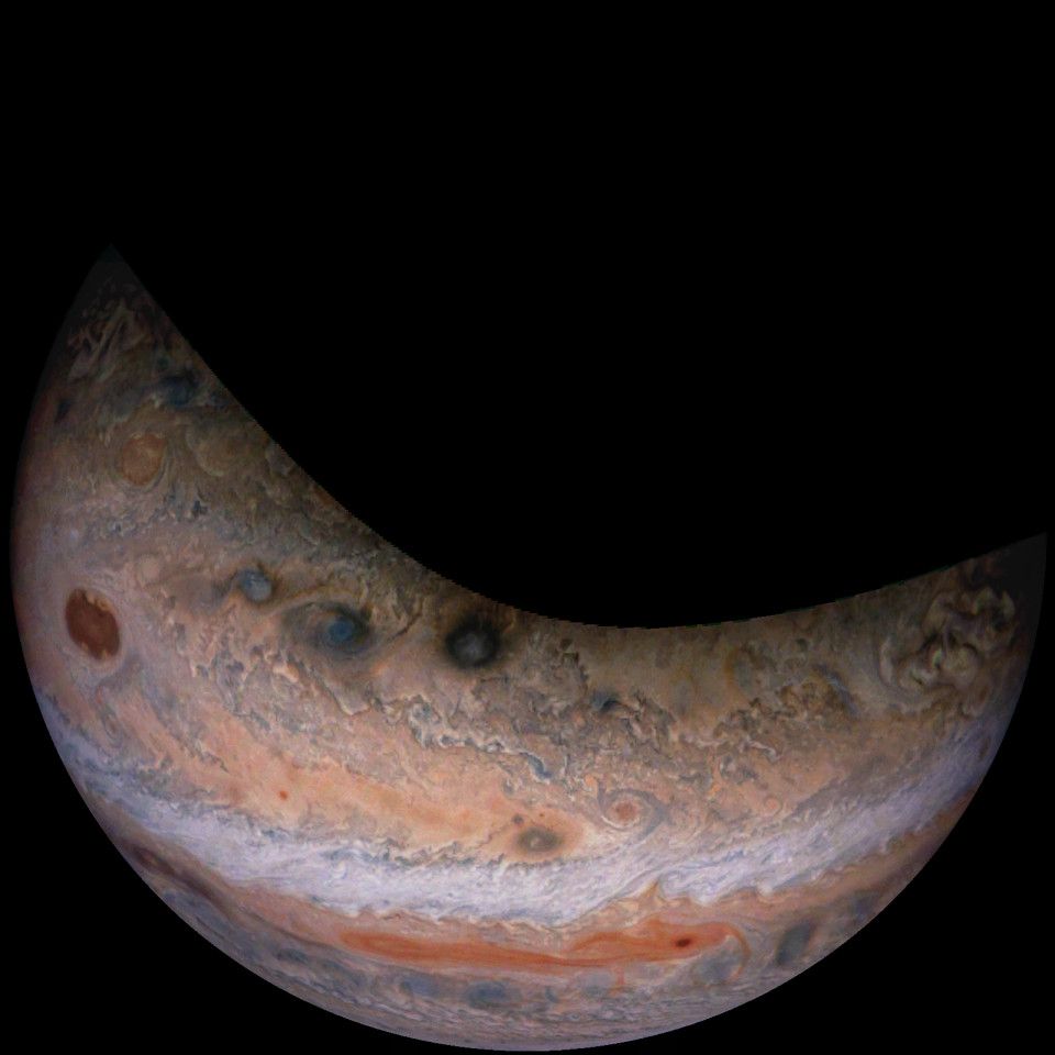 Photo of some of Jupiter's cloud bands, taken from high above its northern hemisphere. Multiple storm systems can be seen spread throughout the area.