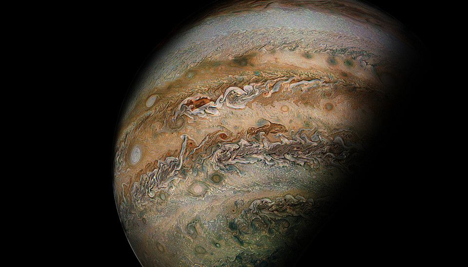Picture of Jupiter's southern hemisphere, spanning from the south polar hood area up to just past the planet's equator, with multiple storm systems across the cloudtops.