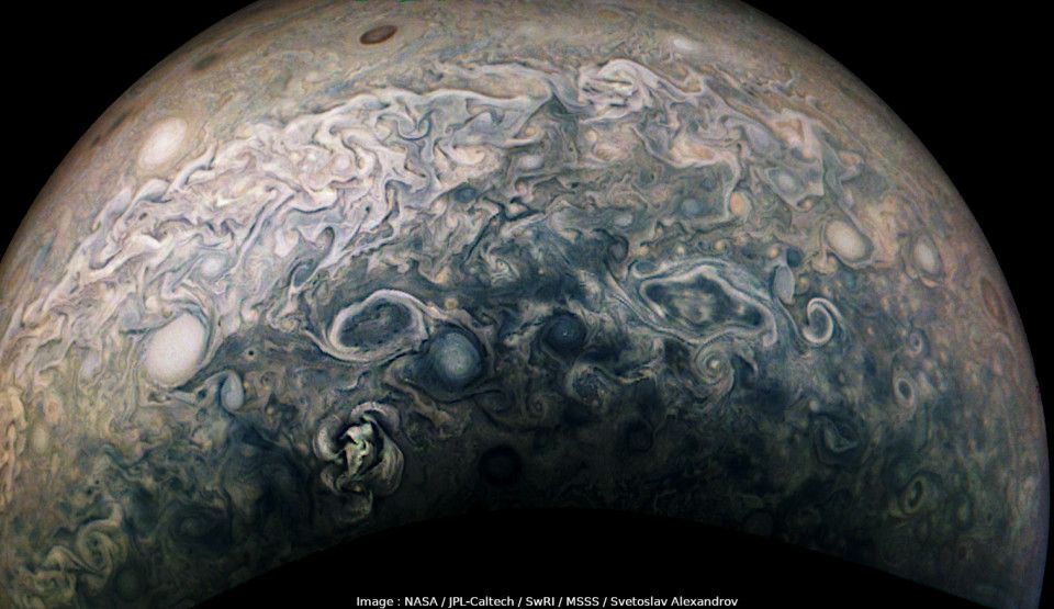 Photo of Jupiter's high latitudes, showing countless turbulent storm systems in the area bordering the southern polar hood.