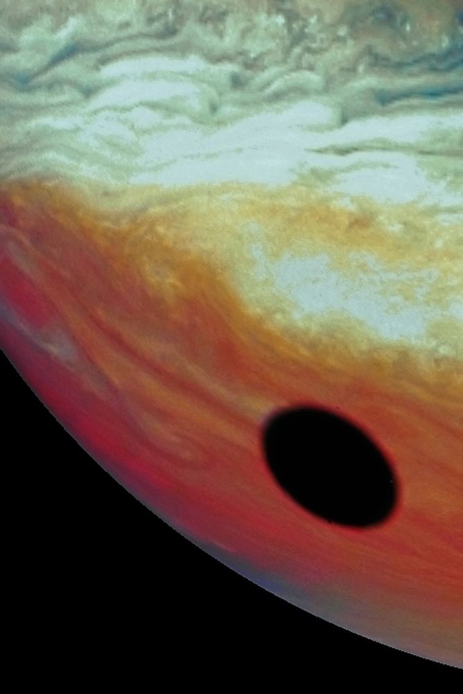 Close-up view of the shadow cast by one of Jupiter's moons over the planet's cloudtops.
