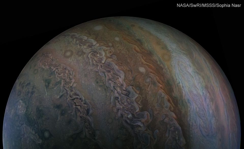 Wide angle shot of planet Jupiter, spanning many of its cloud bands and part of the south polar hood region.