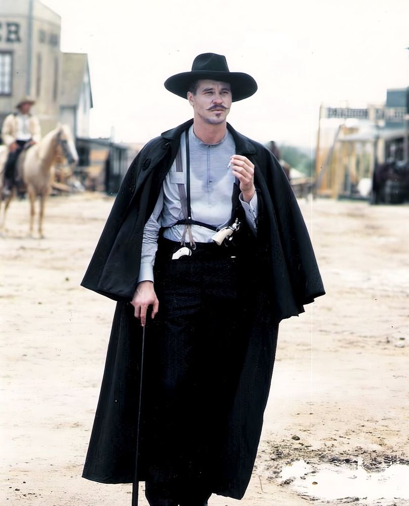 Val Kilmer as Doc Holliday walking with a cane in Tombstone 
