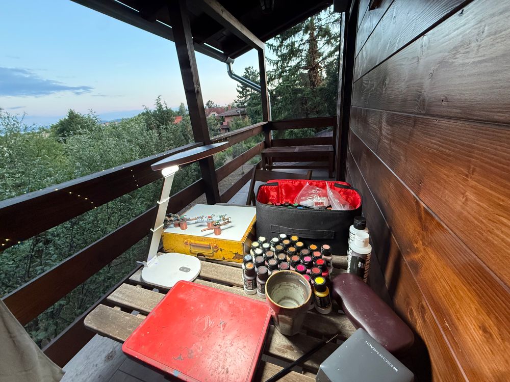 Painting miniatures on the balkony