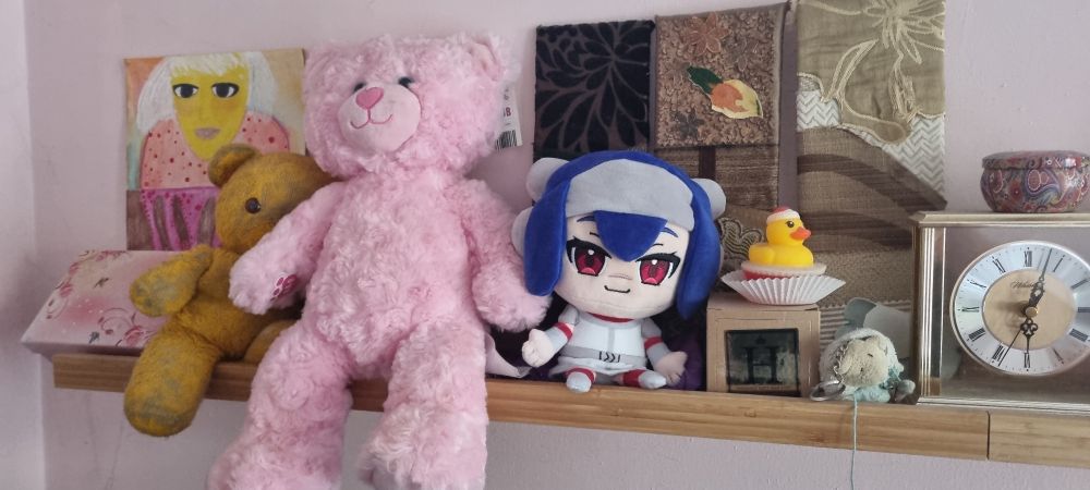 My own Lea plushie, proudly sat on my shelf.
