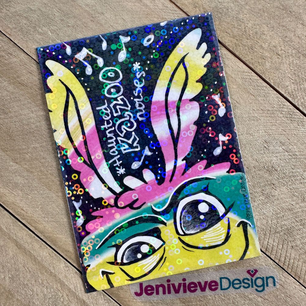 Illustration of a fluffy monster with rainbow fur by Jenivieve Design.