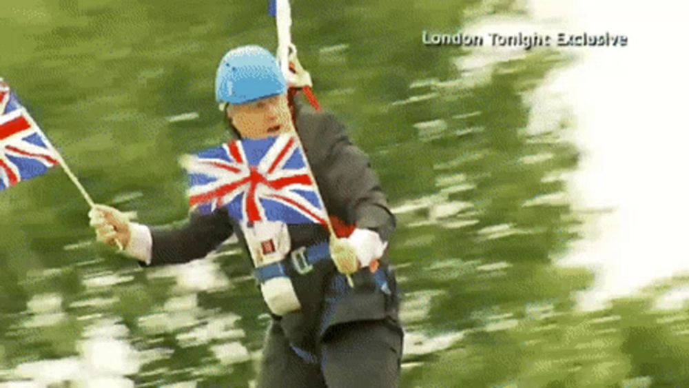 a man in a suit and blue helmet is holding a british flag in a london tonight exclusive