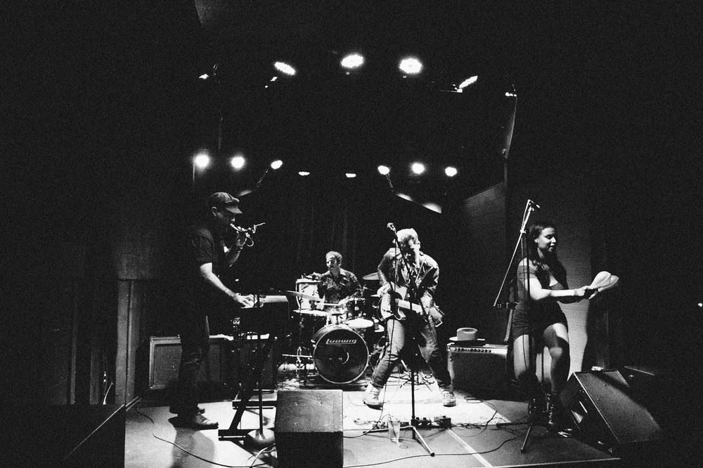 A black and white photo of four-member garage rock band The Jungo Swank during a performance 