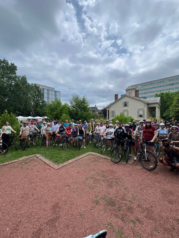 Group photo of a bunch of cyclists in the Chicago Women’s Park and Gardens about to leave for the F+T Bike Sox collab ride. 