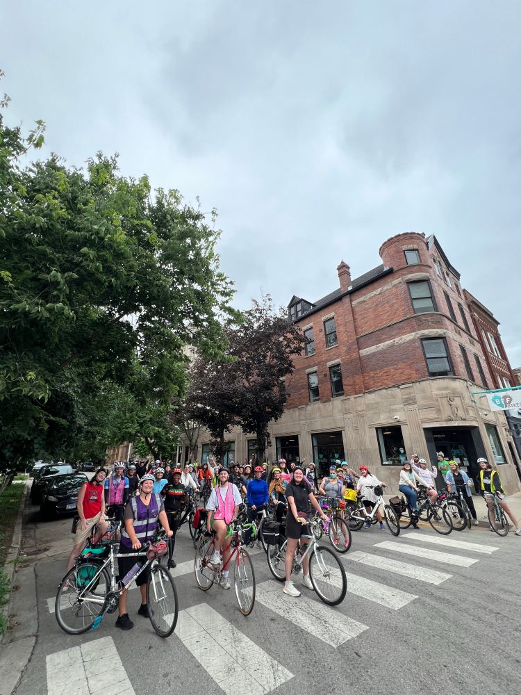 A diverse and lovely crowd of bike riders about to bike together 