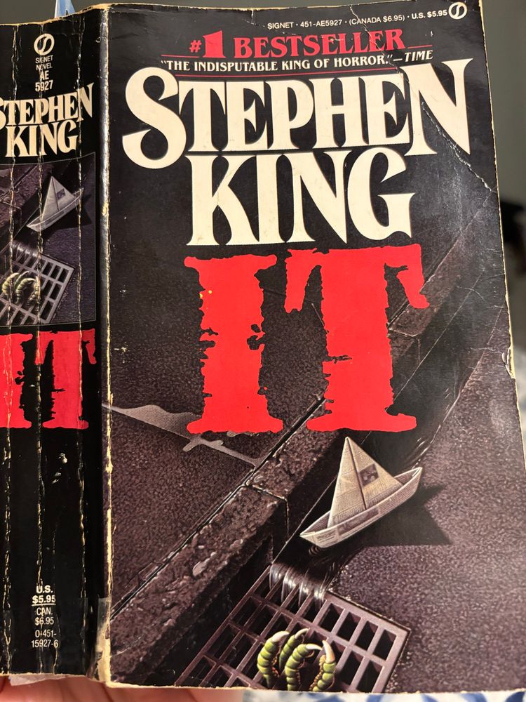 An old well-read paperback copy of IT by Stephen King 