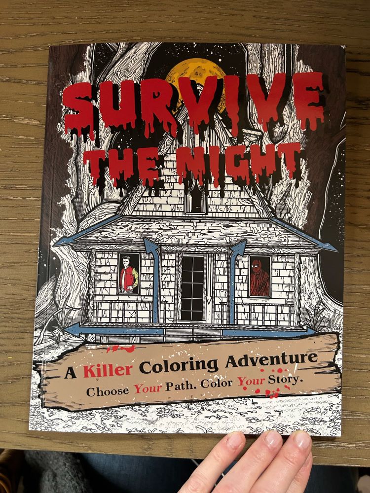 Cover of a coloring book called Survive the Night; A Killer Coloring Adventure. Choose your path. Color your story. It has an image of a haunted looking house. 