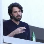 Ben Affleck smoking a cigarette and looking depressed