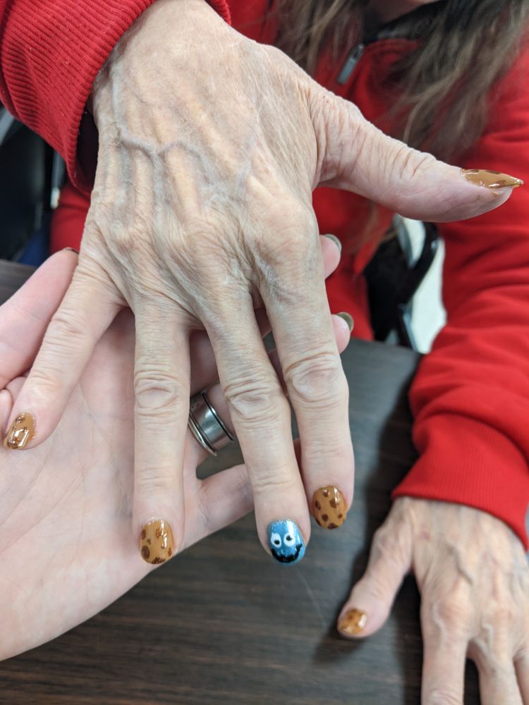 nail design with Cookie Monster on the middle finger in blue and the rest of the nails painted like cookies