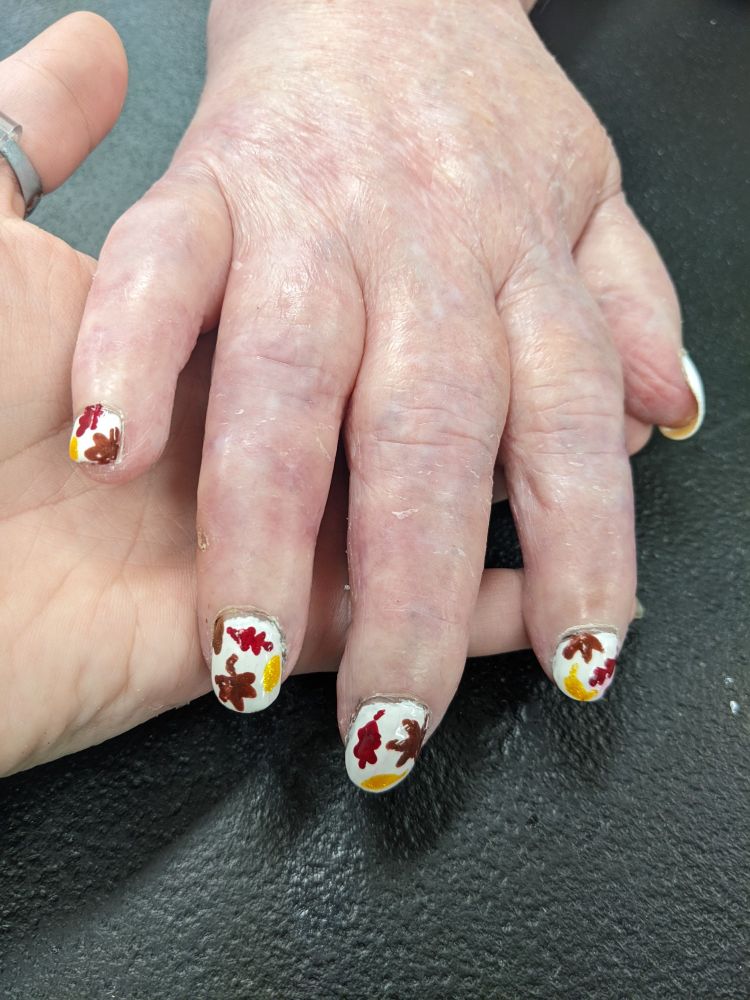 nail design with autumn leaves in various colors on a white background