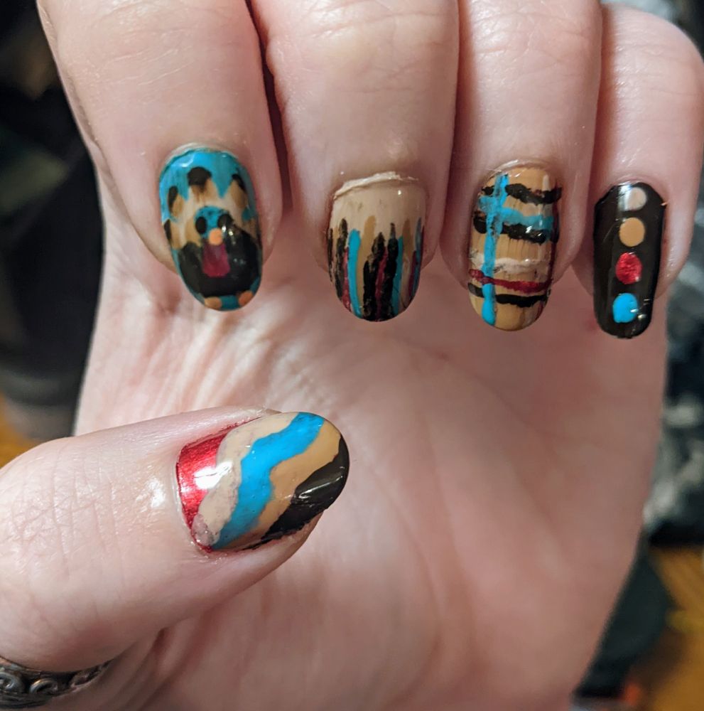 a thanksgiving nail design, with a wild turkey on one finger and various geometric designs in red, teal, and browns