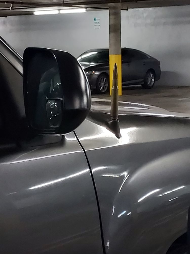 A Toyota Tacoma with a bullet and shell casing replace the antenna 