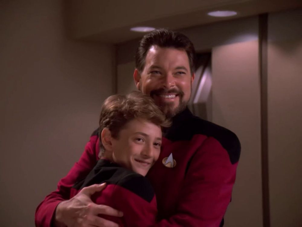 Jean-Luc Picard as a young boy hugging Commander Riker.