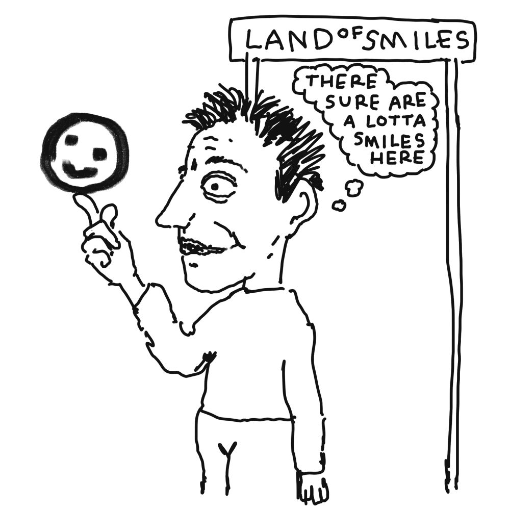 A man holds up a smiley face, and thinks, 