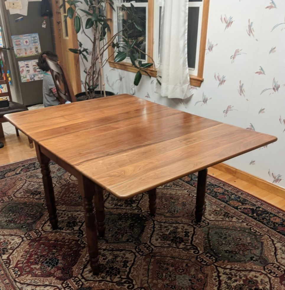 Picture of a walnut table in a dining room 