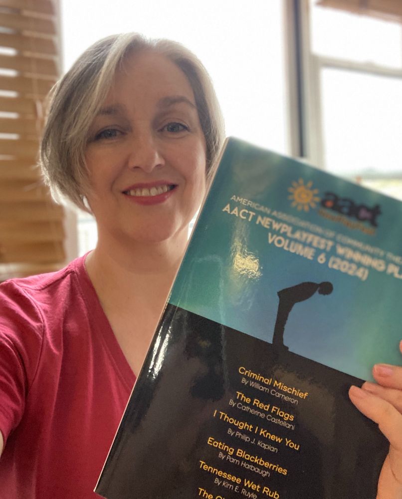 Author holding up a copy of her book