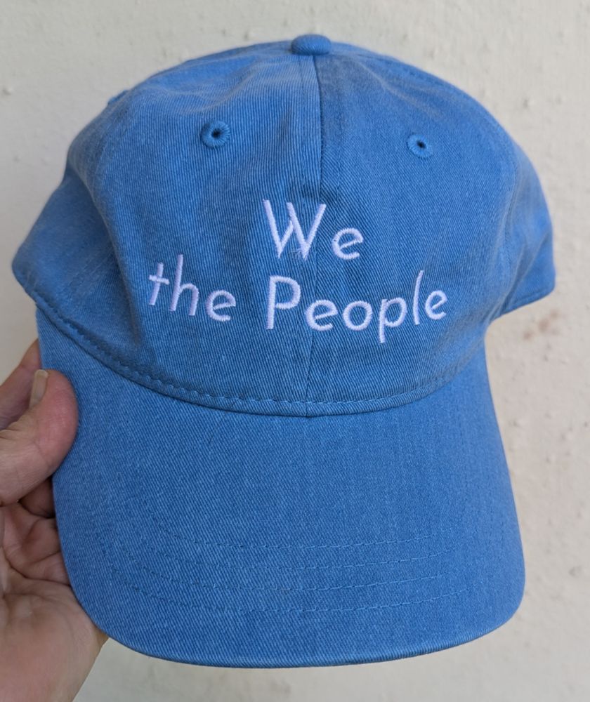 Blue cap with white letters that read 