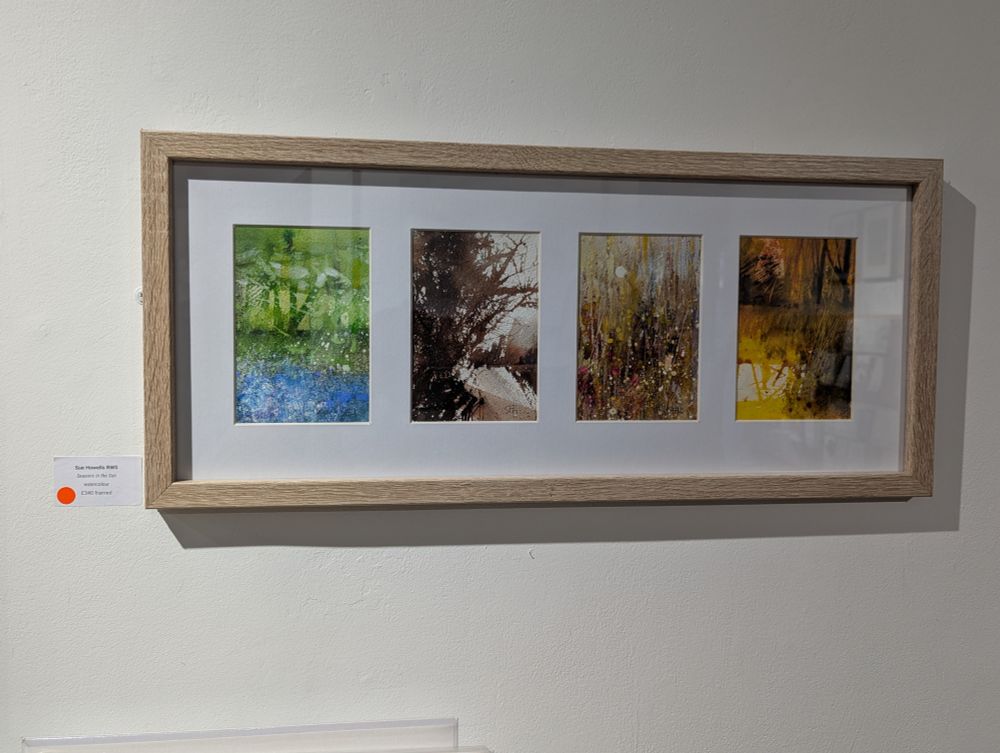 Framed watercolour group of small paintings by RWS member Sue Howells, on display in London. Title "Seasons in the Sun". Each panel in the grouped/matted set shows different colours and mood of small landscapes painted in semi-abstract style. https://www.royalwatercoloursociety.co.uk/ Photo by Ellen Friedman