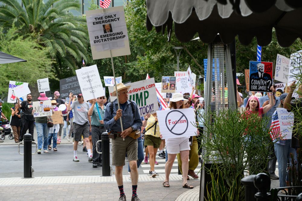 People marching in San Jose CA on 16 Aug 2025 carrying anti-tRump, pro-democracy signs. https://www.probonophoto.org/2025/FTTT/16Aug25SanJoseFightTrump/i-pzWkRTt/A
