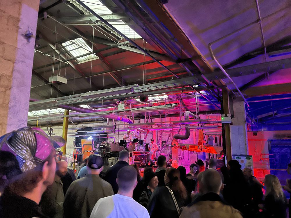 Inside of the factory a gig with a percussion band consisting of 4 drummers