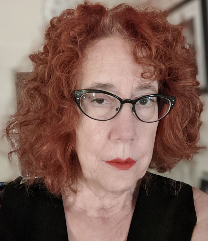 The author in a warm, pinky red lipstick. Bilateral symmetry is for losers.