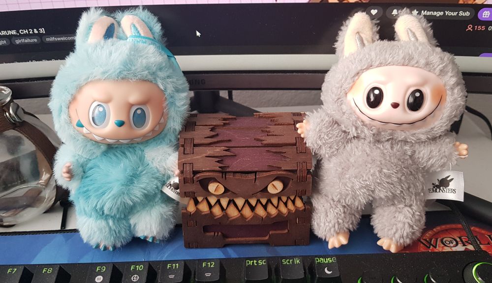 A labubu, a mimic trinket box, and a lafufu with eerily similar toothy grins