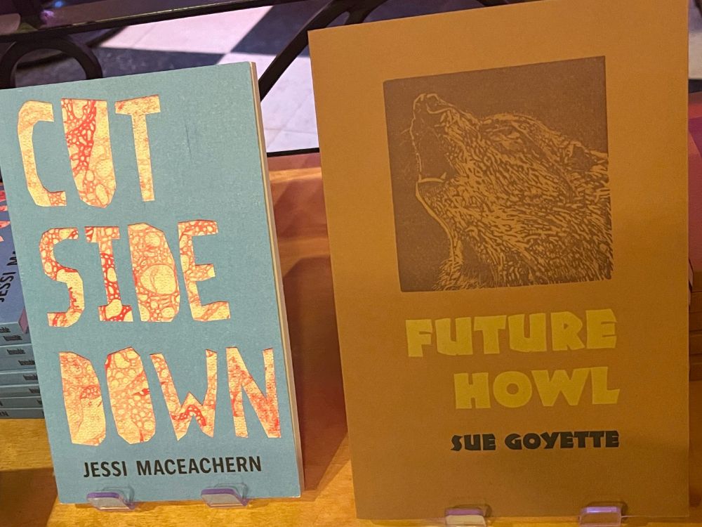 Book covers for 
1. Cut Side Down, poetry by Jessi MacEachern ‪(Invisible Publishing), with the title text cut out of blue paper, revealing patterned red beneath. Cut Side Down feasts on books. Diving face-first into the bookcase, MacEachern calls up the pleasure and pain of influence in sumptuous, body-and-mind-bending poems. Here Virginia Woolf, Orlando, and companions attend salons hosted by Clark Coolidge and Renee Gladman, while Lorine Niedecker scolds Charles Olson in class. There are glimpses of the poet too—a lost boy in rural Prince Edward Island, a young woman in Montréal—as she concocts worlds and words. Immersed in a life of reading, and spying through the keyholes of fantasy, Cut Side Down melds lyric and conceptual experiment in a delightful banquet of autobiography, desire, invention, landscape and memory. https://invisiblepublishing.com/product/cut-side-down/
2. Future Howl by Pat Lowther and Bliss Carman award-winning poet Sue Goyette (Gaspereau Press), with a letterpress wolf on a brown background. Sue Goyette’s poem Future Howl plots a fulsome radius of the experience of trauma and survival, one that encompasses much about living in the aftermath that skirts straightforward description and yet works in the frequency of courage and joy. Propelled by Goyette’s declarative voice, sense of humour and side-slipping imagery, each page of the poem is “a microdose of ars poetica” infused with intertextual and transformative guidance from the painter Bob Ross, the live-cam company of a pair of endangered red wolves, and a private-to-public reckoning that is grounded in this singular time. http://www.gaspereau.com/bookInfo.php?AID=0&AISBN=9781554472796