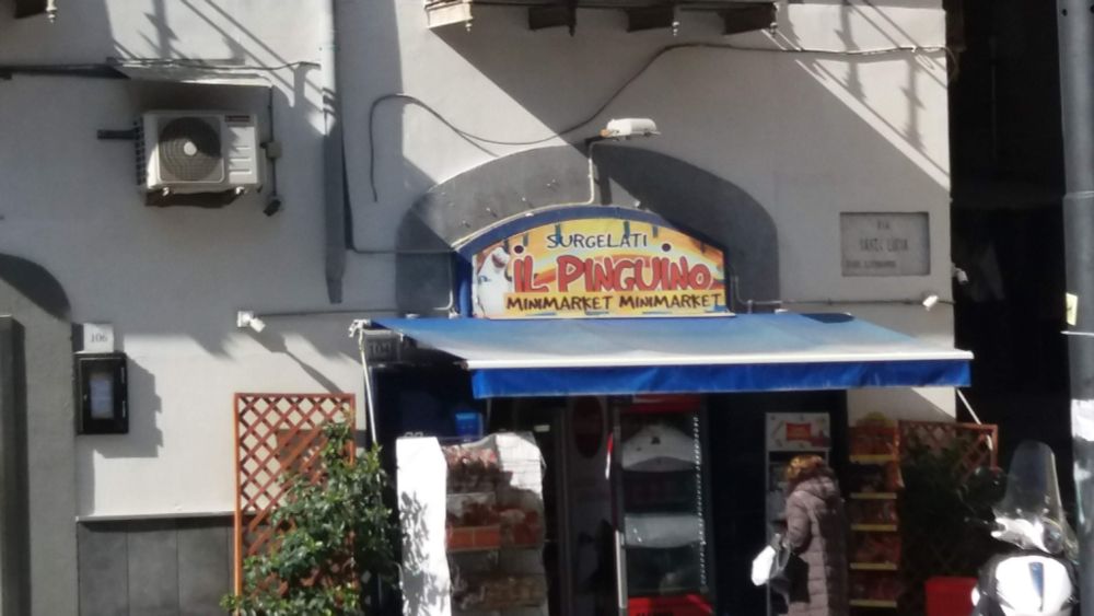 An Italian minimarket featuring a character from Penguins of Madagascar. Photo from February 2022.
