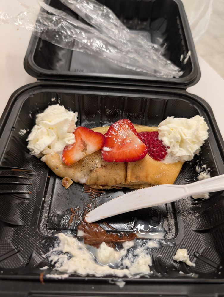 Half devoured Nutella and strawberry crepe
