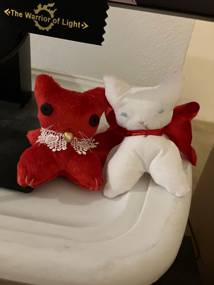 Two handmade kitten plushes sit together. They are friends!