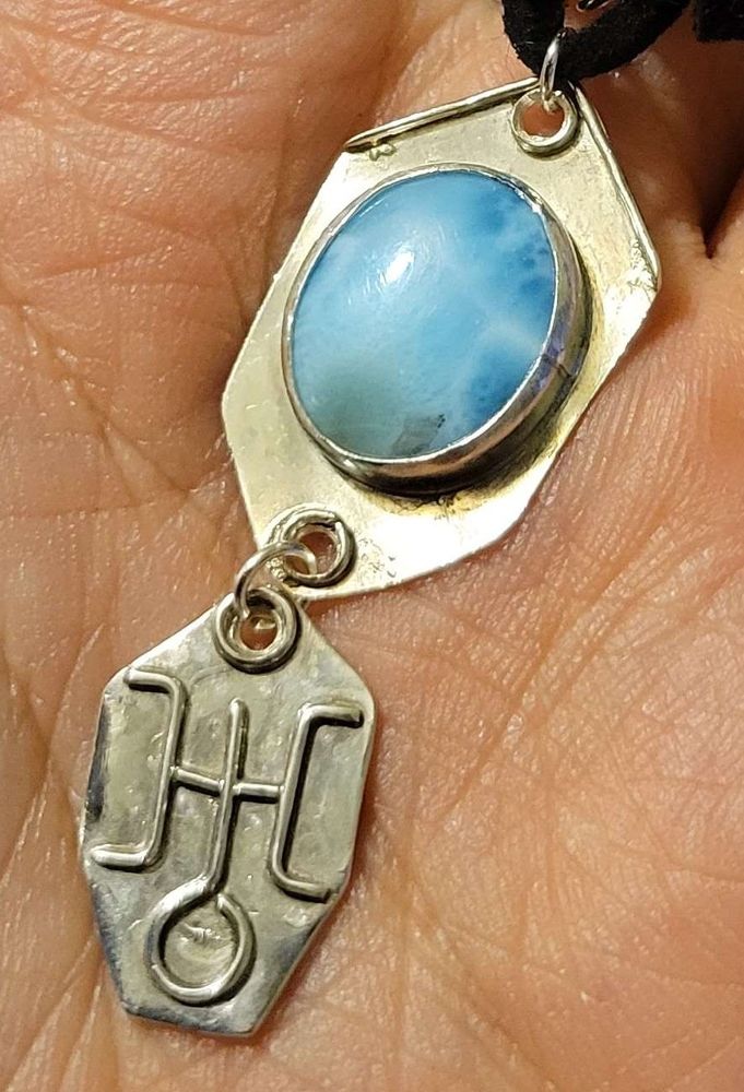 Pendant featuring a Larimar and a small charm under with one of the symbols used for the planet Uranus