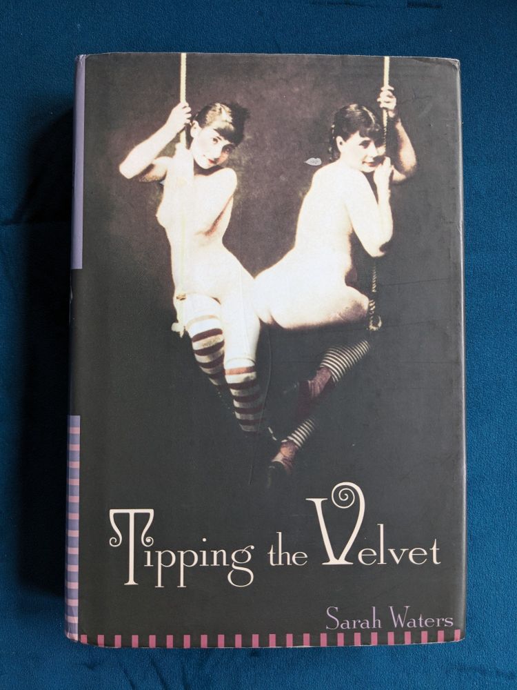 Photo of the book 'Tipping the Velvet' by Sarah Waters on a teal velvet fabric.