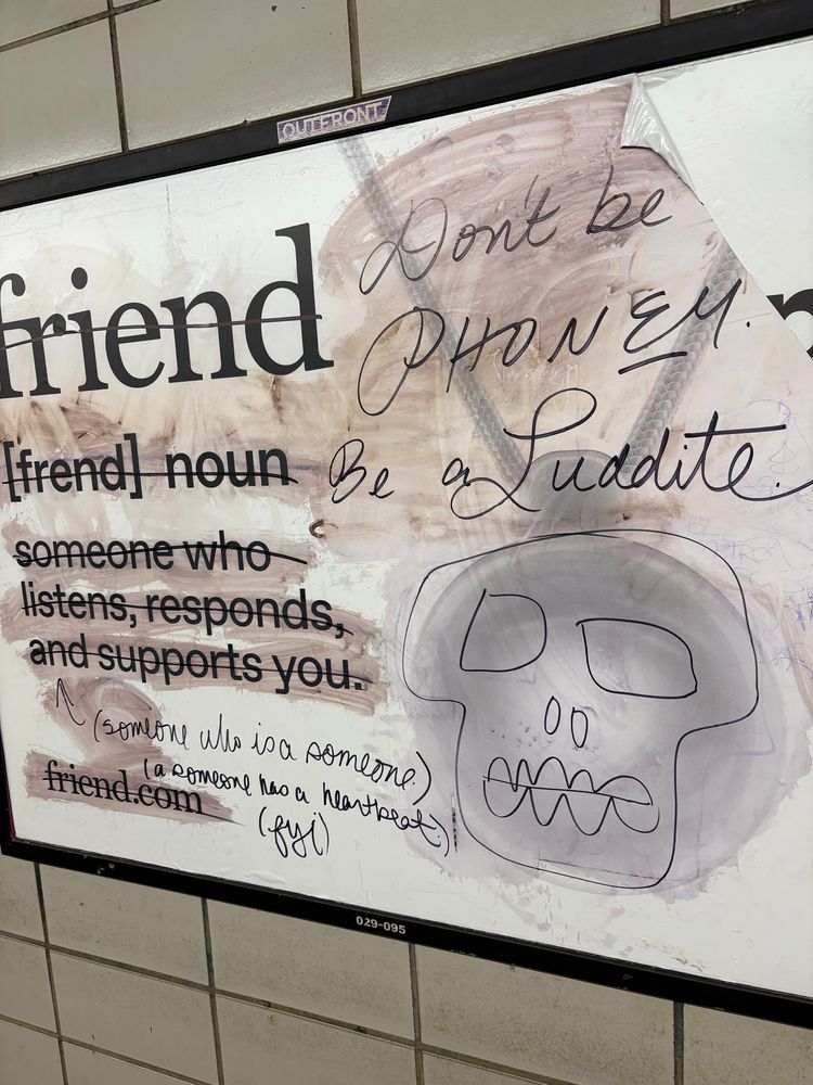 the stupid AI friend device as crossed out with the words DONT BE PHONEY BE A LUDDITE