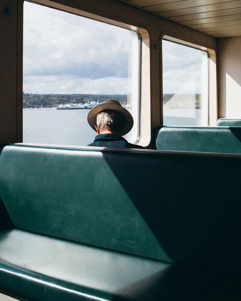 Photograph by Arnaud Montagard of a man in a hat riding a ferry