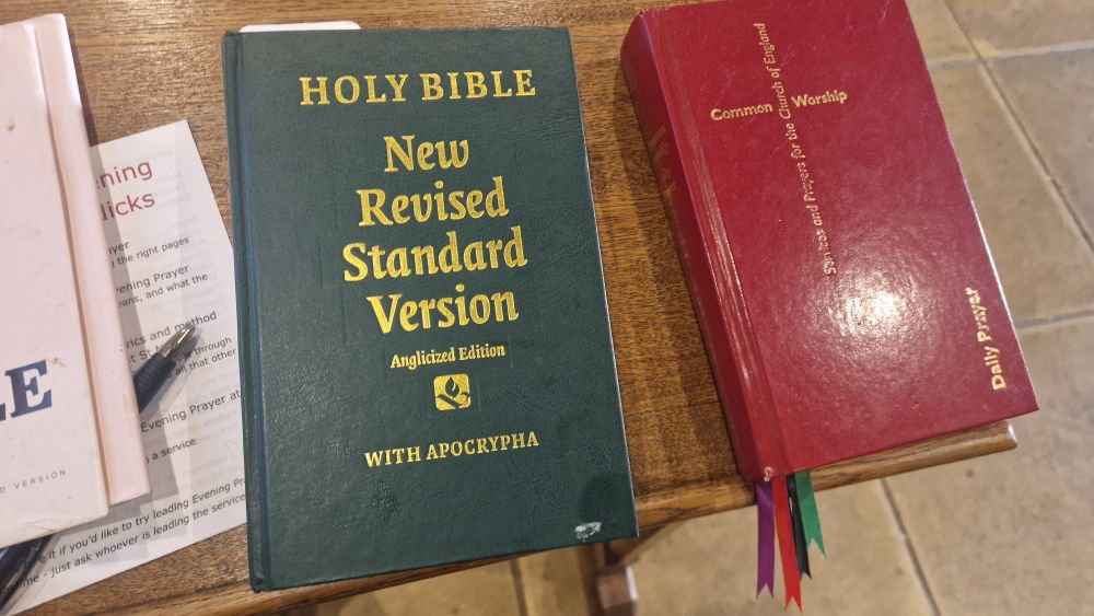 A Green Bible next to a red Common Worship Daily prayer 

In gold on the Bible it says 
HOLY BIBLE
New
Revised
Standard
Version
Anglicised Edition
WITH APOCRYPHA 

They are on a prayer desk