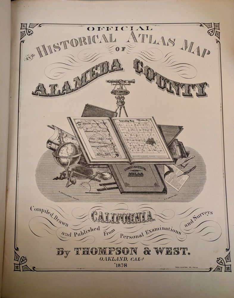 Title Page from the 1878 "Official and Historical Atlas Map of Alameda County, California" by Thompson & West. The title of the atlas is at the top of the page, the publisher information at the bottom. At center is an illustration of an open atlas resting on a pile of closed atlases, cartography tools, and rolled maps. 