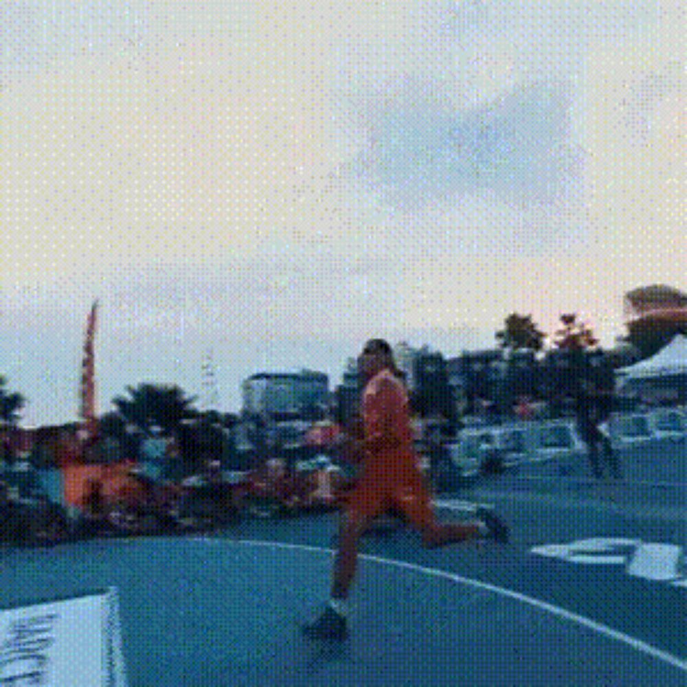 a man in an orange shirt is running on a basketball court with a sign that says gatorade on it