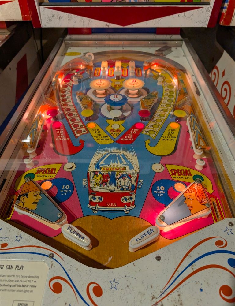 Bus Stop playfield. Two flippers, three pop bumpers.