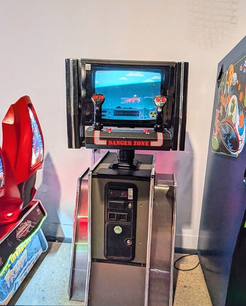 Danger Zone arcade cabinet. Silver chrome and black.