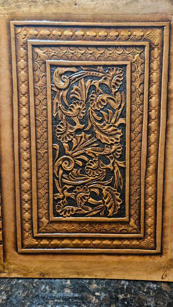Detail of leather journal cover showing floral carving. 